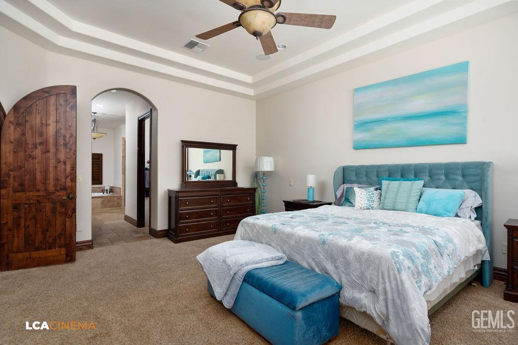 Undisclosed Address Keene, CA 93531 - Photo 20 of 46 a bedroom with a bed and a chandelier