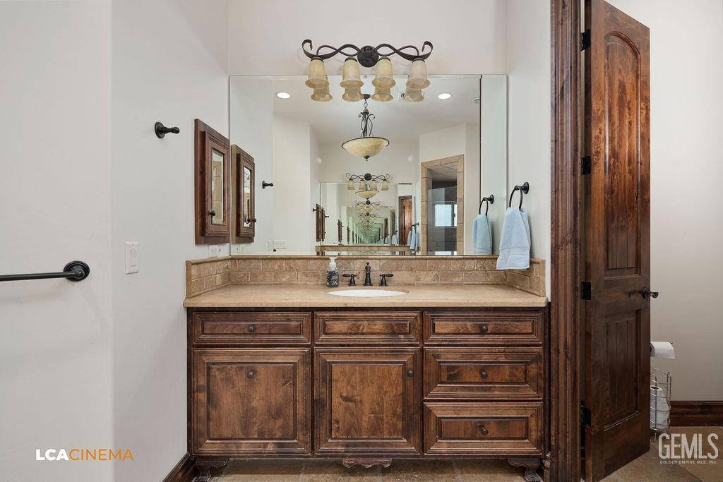 Undisclosed Address Keene, CA 93531 - Photo 22 of 46 a bathroom with a granite countertop sink a large mirror and a shower