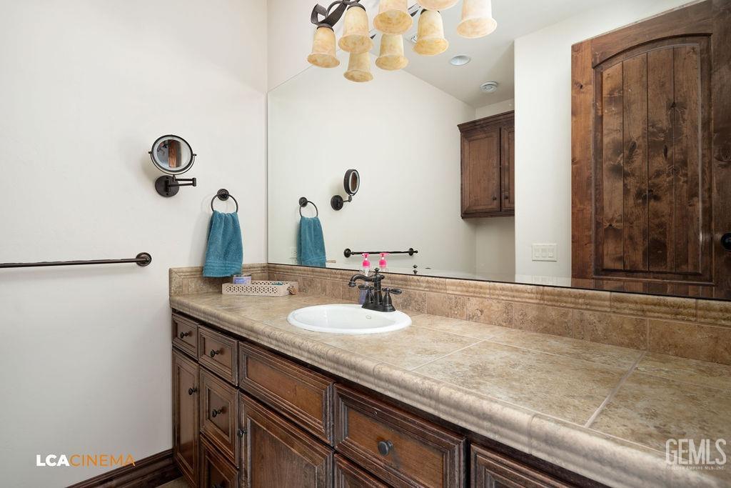 Undisclosed Address Keene, CA 93531 - Photo 26 of 46 a bathroom with a granite countertop sink and a mirror