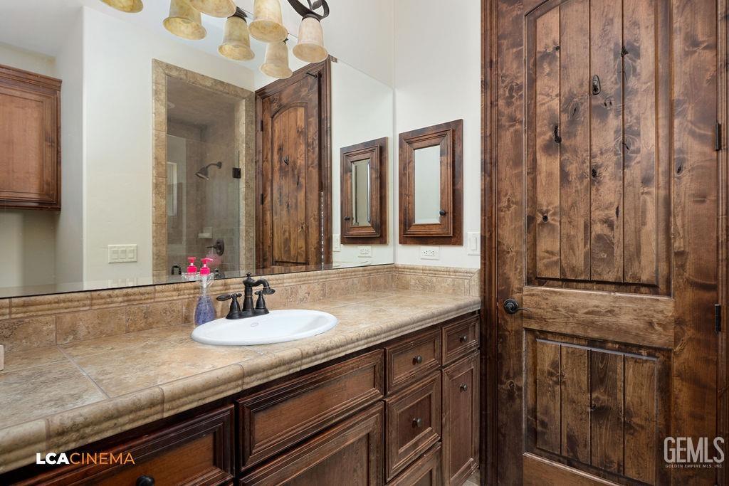 Undisclosed Address Keene, CA 93531 - Photo 27 of 46 a bathroom with a granite countertop sink and a mirror