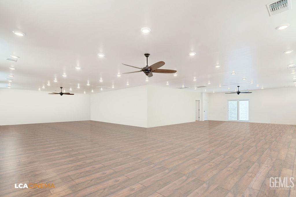 Undisclosed Address Keene, CA 93531 - Photo 39 of 46 an empty room with wooden floor ceiling fan and windows