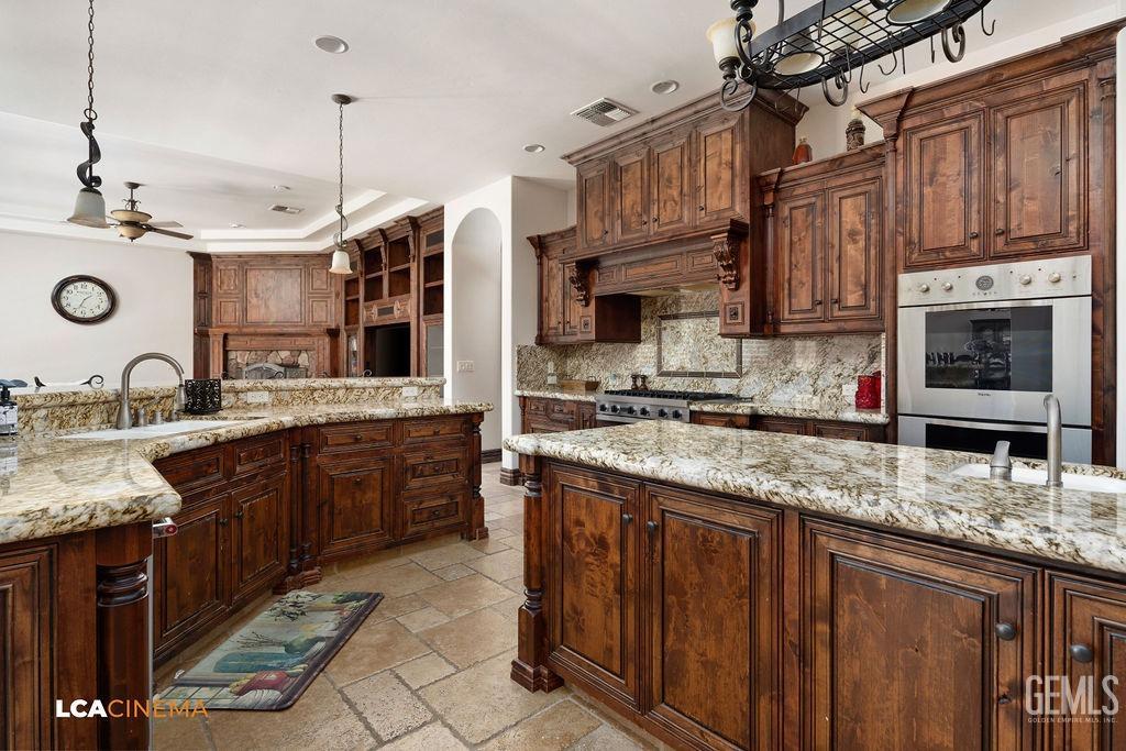 Undisclosed Address Keene, CA 93531 - Photo 9 of 46 a kitchen with stainless steel appliances granite countertop a sink a stove and a wooden cabinets
