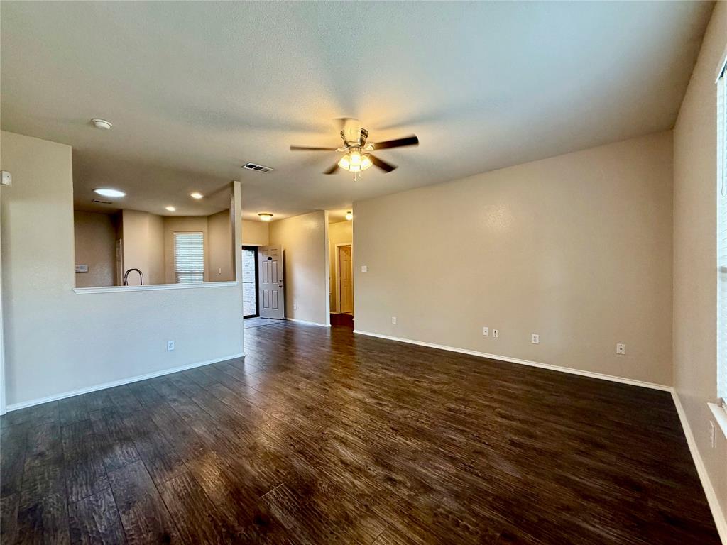 5817 Deck House Road Fort Worth, TX 76179 - Photo 4 of 19 Expansive open-concept living space featuring wood-finish flooring, neutral wall tones, and recessed lighting