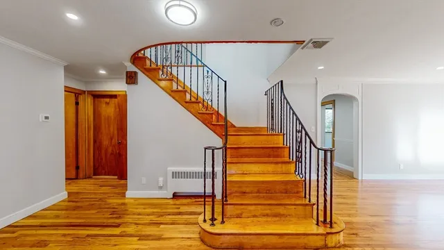 a view of an empty room with wooden floor