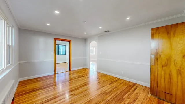 a view of an empty room with a cabinet
