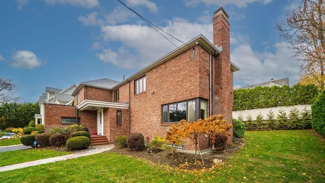 a view of a yard with an tree and a wooden fence