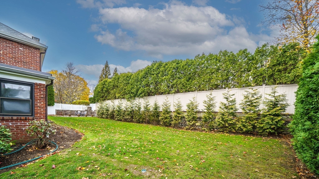 36 Lorna Road, Unit SF Newton, MA 02459 - Photo 6 of 25 a view of a yard with an tree and a wooden fence