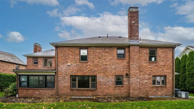 a view of a house with a yard and furniture