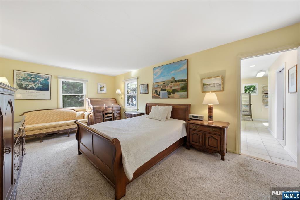 168 Engle Street Tenafly, NJ 07670 - Photo 25 of 50 a spacious bedroom with a bed and a couch