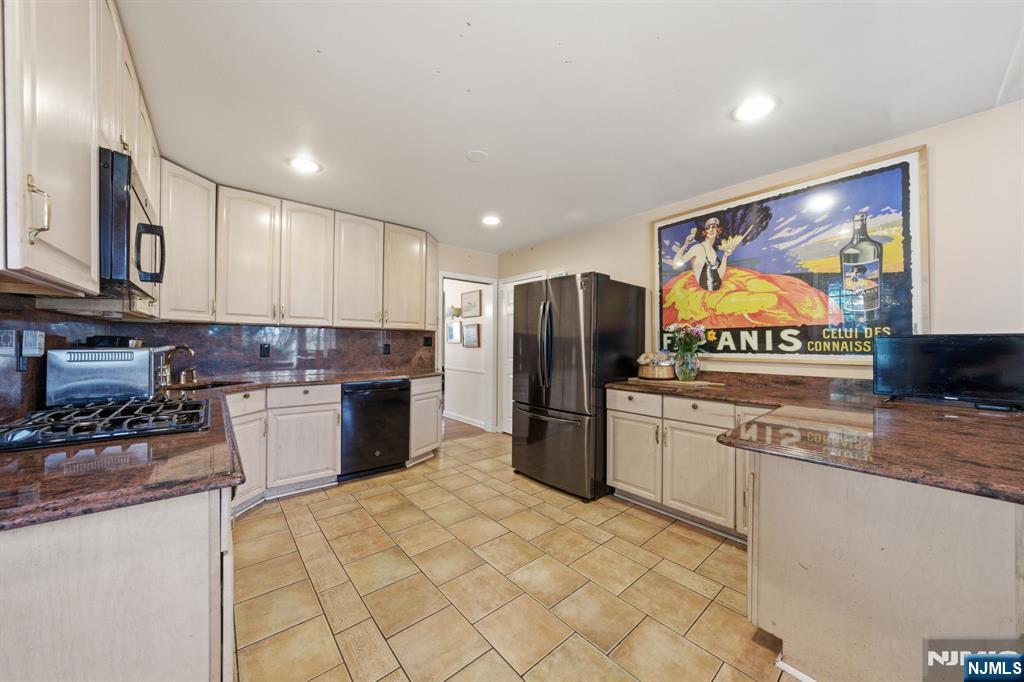 168 Engle Street Tenafly, NJ 07670 - Photo 6 of 50 a kitchen with stainless steel appliances granite countertop a refrigerator and a stove top oven
