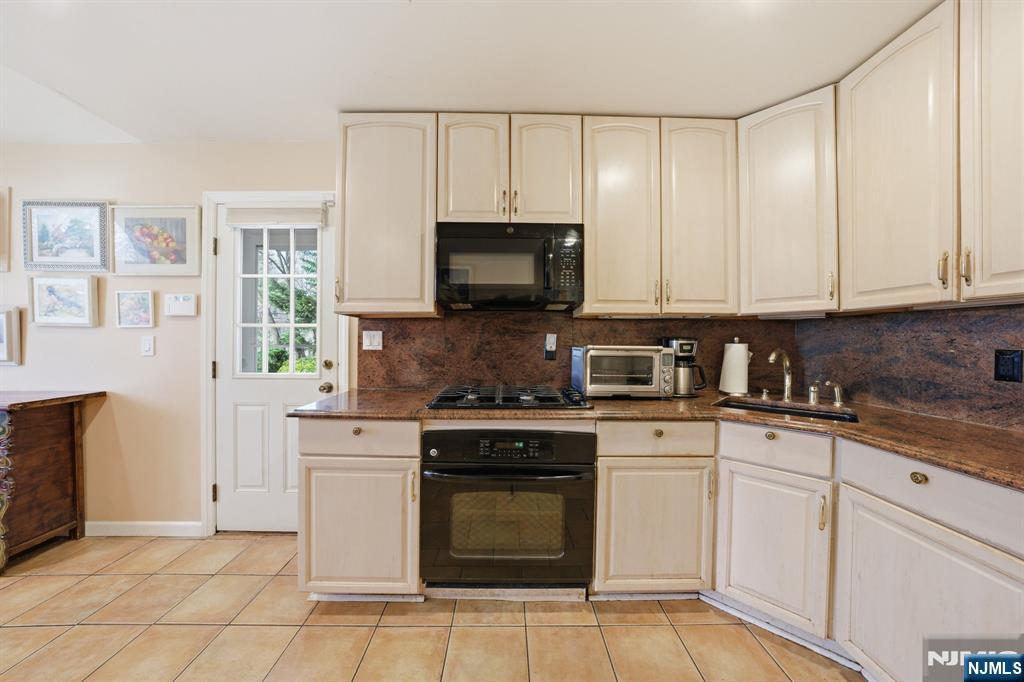 168 Engle Street Tenafly, NJ 07670 - Photo 7 of 50 a kitchen with granite countertop white cabinets and stainless steel appliances