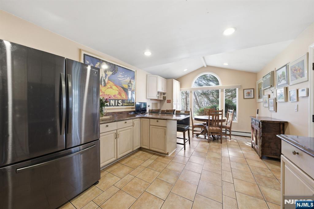 168 Engle Street Tenafly, NJ 07670 - Photo 8 of 50 a kitchen with granite countertop stainless steel appliances a refrigerator a dining table and chairs