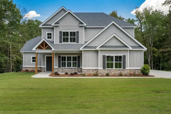 a front view of a house with a garden and porch