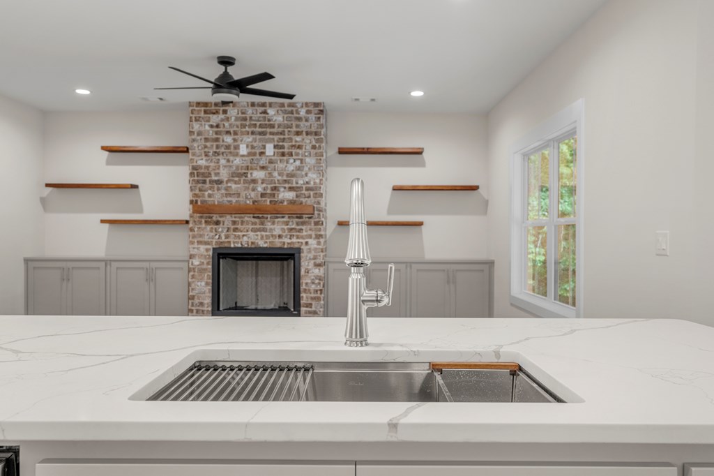 299 Ridgeway Drive Cataula, GA 31804 - Photo 13 of 52 a view of kitchen with kitchen island sink and fireplace