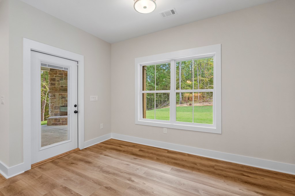 299 Ridgeway Drive Cataula, GA 31804 - Photo 19 of 52 an empty room with wooden floor and windows