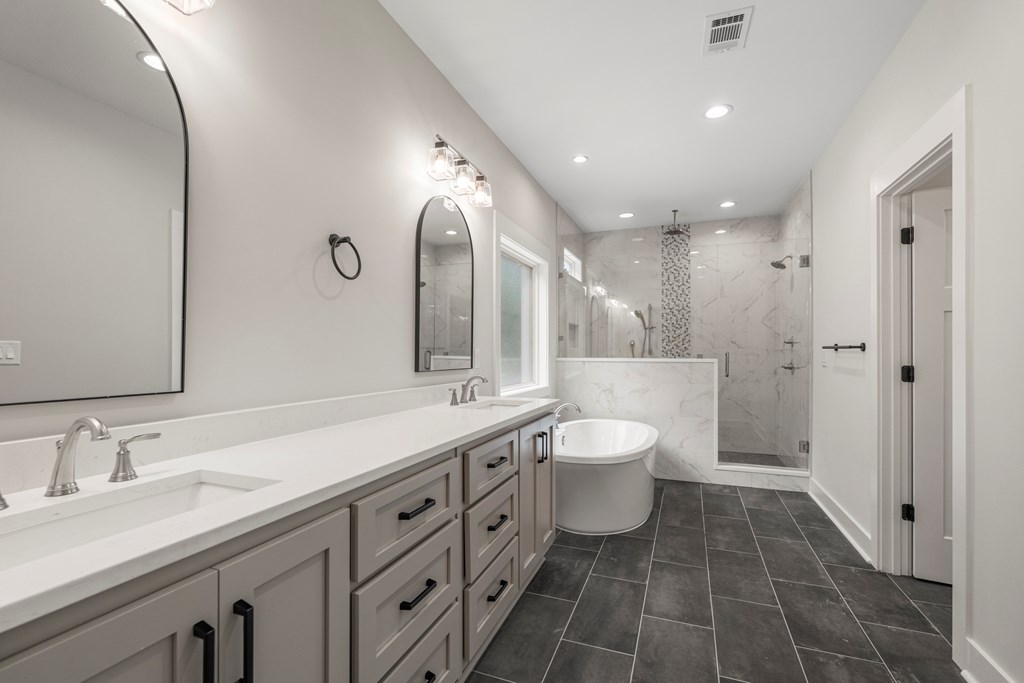299 Ridgeway Drive Cataula, GA 31804 - Photo 27 of 52 a spacious bathroom with a double vanity sink mirror double and bathtub