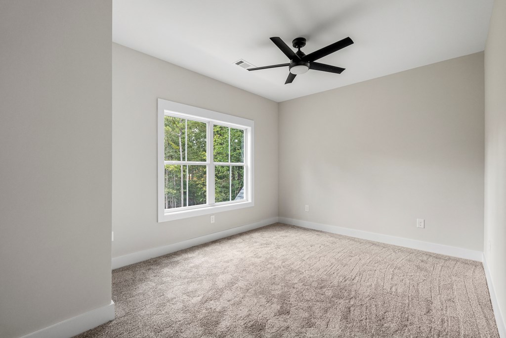 299 Ridgeway Drive Cataula, GA 31804 - Photo 31 of 52 an empty room with ceiling fan and windows