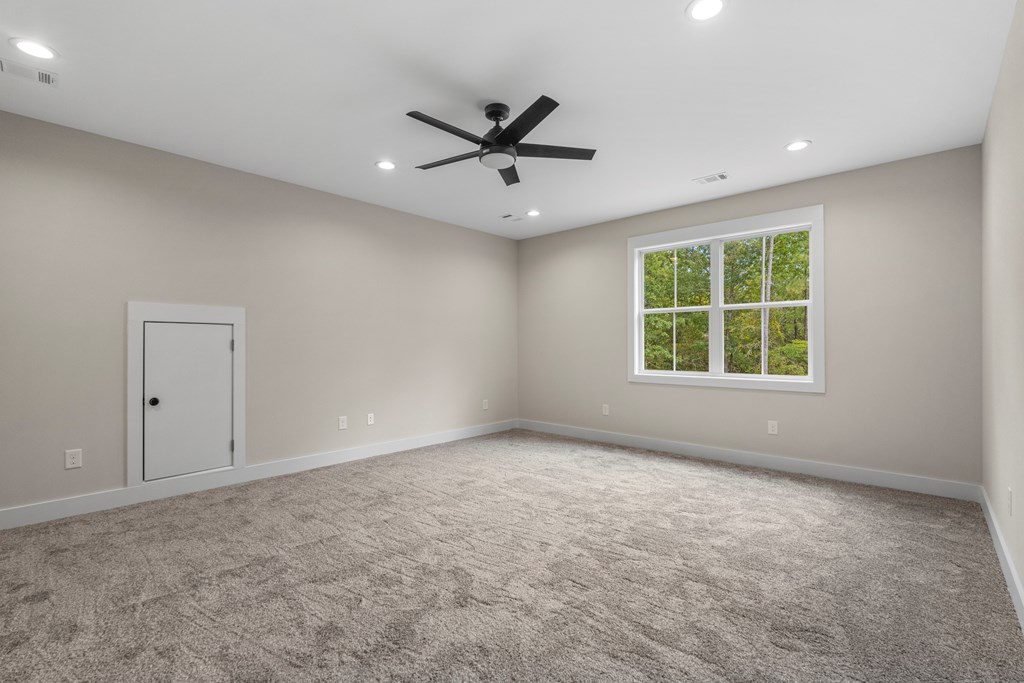 299 Ridgeway Drive Cataula, GA 31804 - Photo 38 of 52 an empty room with windows and ceiling fan