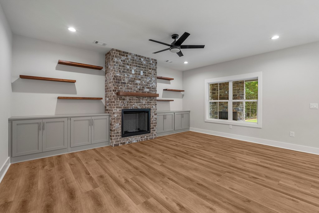 299 Ridgeway Drive Cataula, GA 31804 - Photo 10 of 52 a view of empty room with wooden floor and fireplace