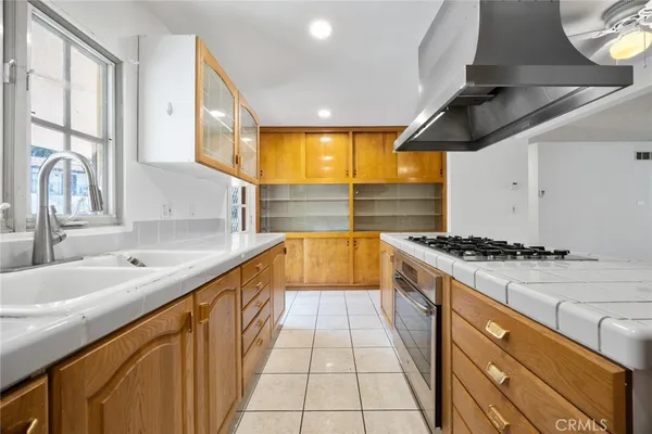 a large kitchen with stainless steel appliances granite countertop a sink and a stove