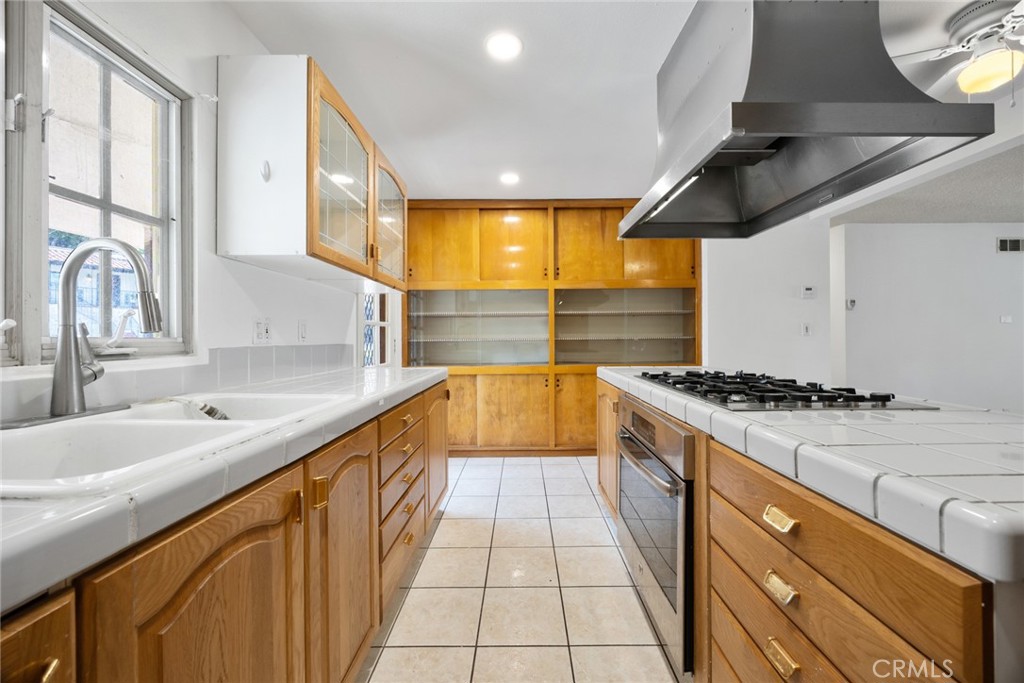 101 Hampden Terrace Alhambra, CA 91801 - Photo 14 of 46 a large kitchen with stainless steel appliances granite countertop a sink and a stove