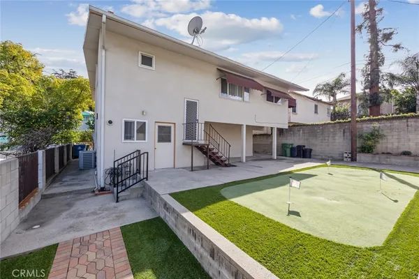 a view of a house with swimming pool and sitting area
