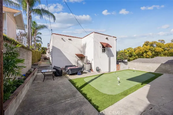 an aerial view of a house with a yard and sitting area