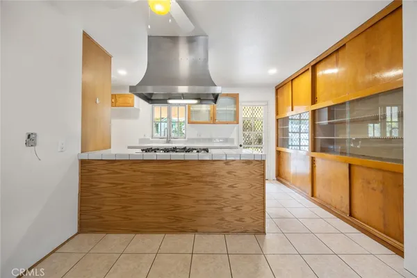 a view of open kitchen with granite countertop a sink and a stove next to a large window