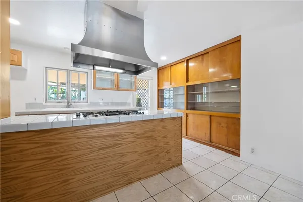 a large kitchen with granite countertop a sink and a stove