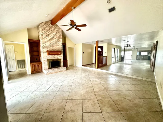 a view of a hall with wooden floor