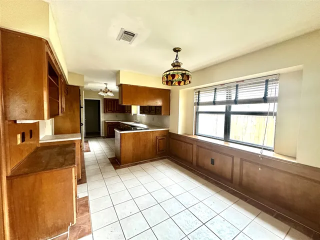 a kitchen with stainless steel appliances kitchen island granite countertop a sink and cabinets