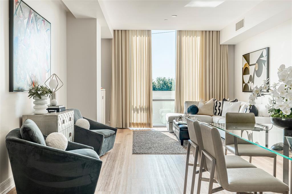 a living room with furniture and large windows