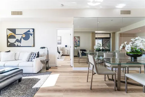 a living room with furniture and flowers