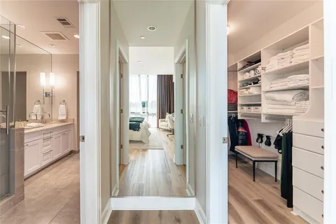 a spacious bathroom with a tub sink shower and a mirror