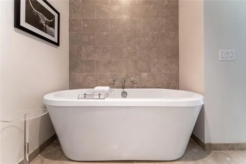 a living room with furniture and wall painting