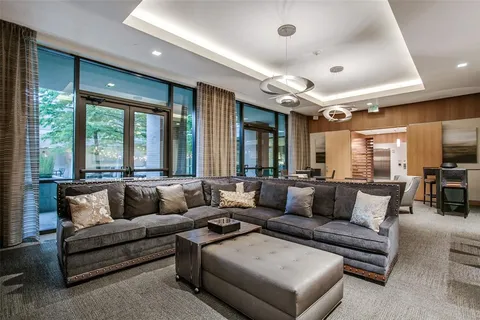 a living room with furniture kitchen view and a large window