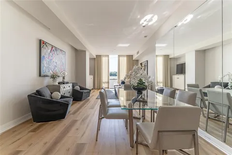 a living room with furniture and a large mirror
