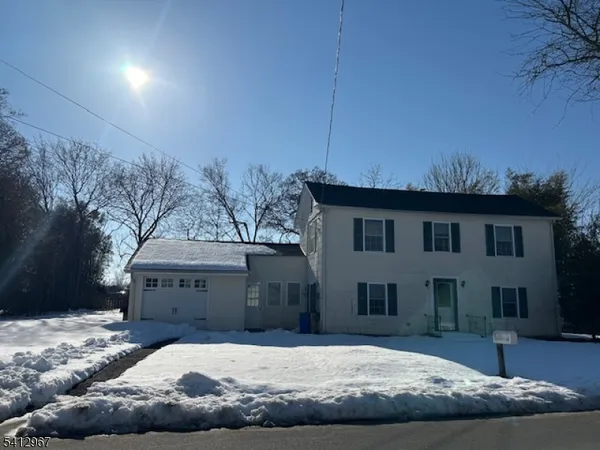 a view of a house with a snow in the yard
