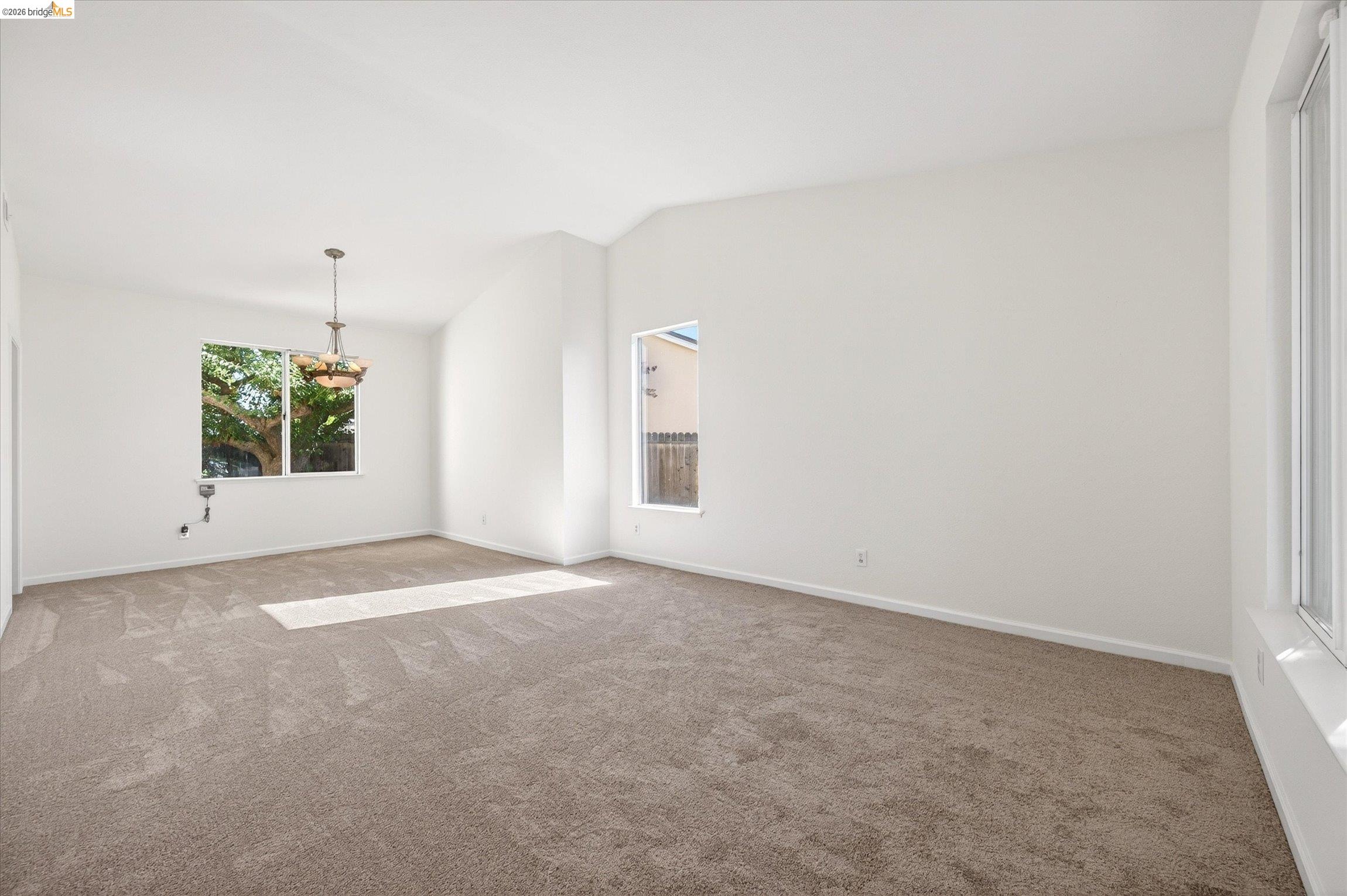 1120 Deerpark Road Oakley, CA 94561 - Photo 7 of 30 Spacious room featuring neutral carpeting, white walls, and a vaulted ceiling