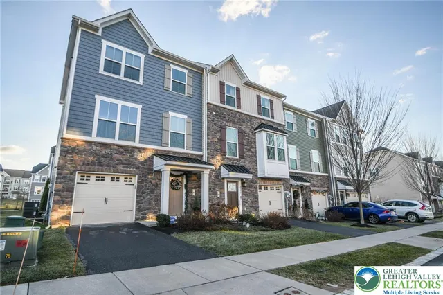 a front view of a residential apartment building with a yard