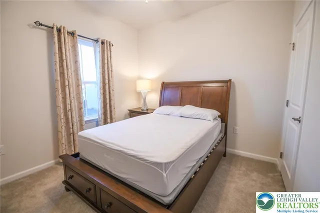 a bed room with a bed and a chair