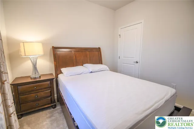 a bedroom with a bed and a lamp