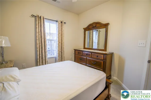 a bedroom with a bed and window