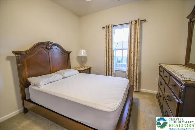 a bedroom with a bed and dresser