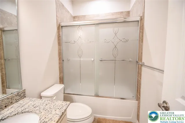 a bathroom with a glass shower door