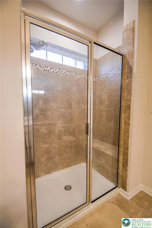 a bathroom with a glass shower door