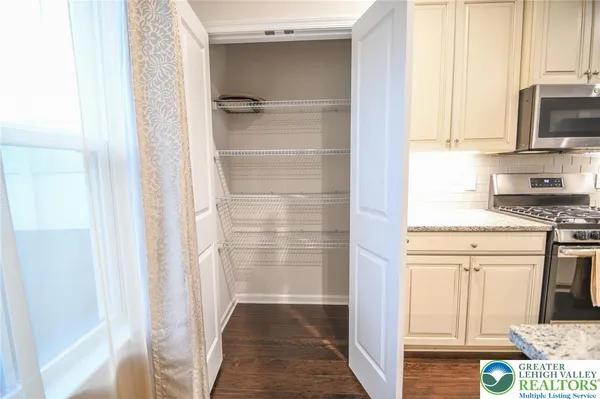 a kitchen with stainless steel appliances a refrigerator and cabinets