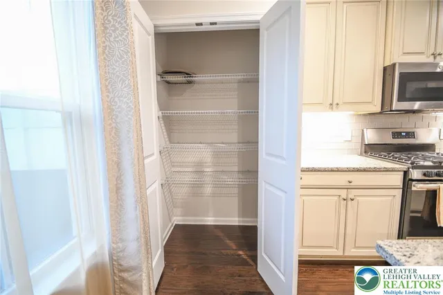 a view of room with window and wooden floor