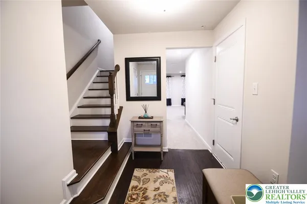 a view of a hallway with entryway and furniture