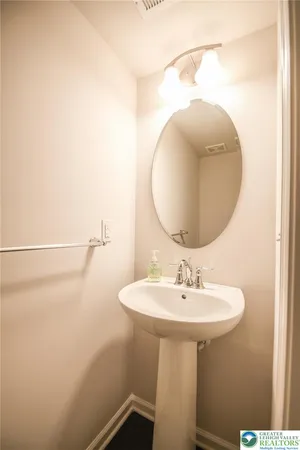 a bathroom with a sink a mirror and vanity